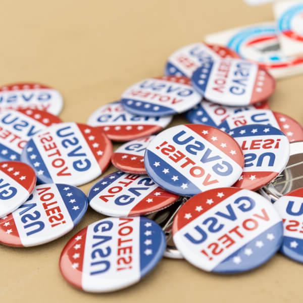 A pile of buttons that read "GVSU Votes!"