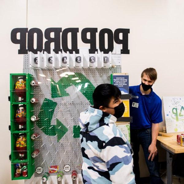 pop drop machine in background, young student laughing, GVSU student in background