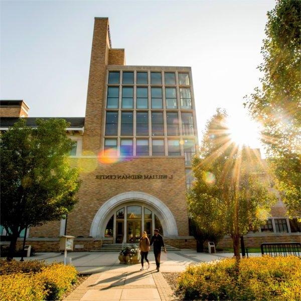 Photo of L. William Seidman Center exterior as students walk by