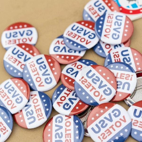 "GVSU Votes" buttons in a pile on a table