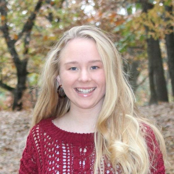 headshot of Christina Vann, outdoors near wooded area